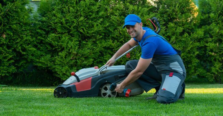 A professional landscaper taking care of a manicured lawn