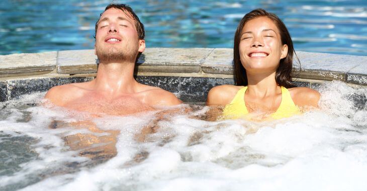 a young couple relaxing in a hot tub