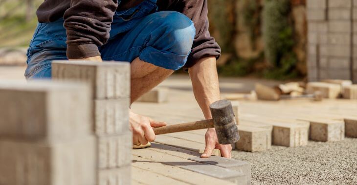 man laying paver